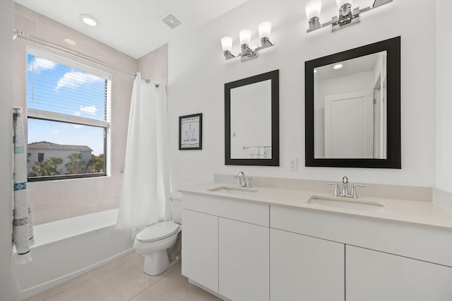 full bathroom with vanity, tile patterned floors, toilet, and shower / bath combo with shower curtain