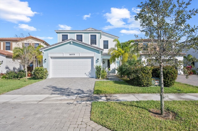 front of property with a garage and a front yard