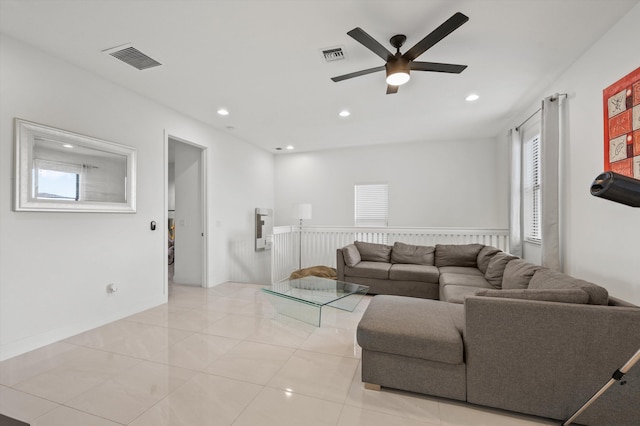 living room featuring light tile patterned flooring and ceiling fan