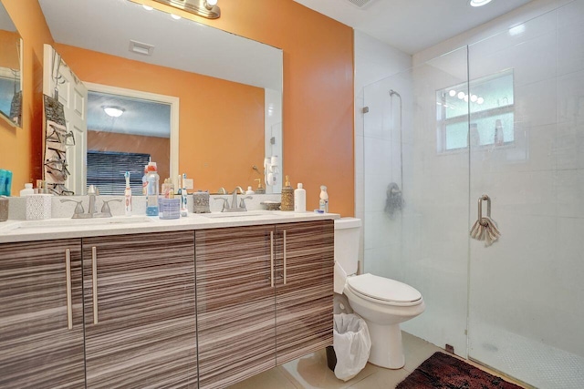 bathroom featuring tile patterned flooring, vanity, toilet, and walk in shower