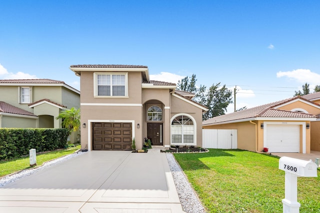 mediterranean / spanish home featuring a front lawn