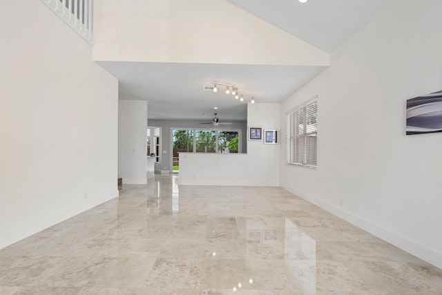 unfurnished living room featuring high vaulted ceiling, a wealth of natural light, and ceiling fan