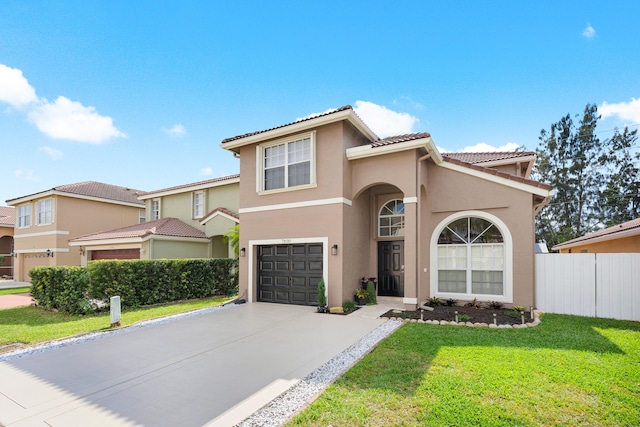 mediterranean / spanish house with a garage and a front yard