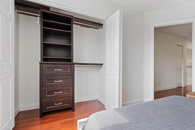 bedroom with wood-type flooring and a closet