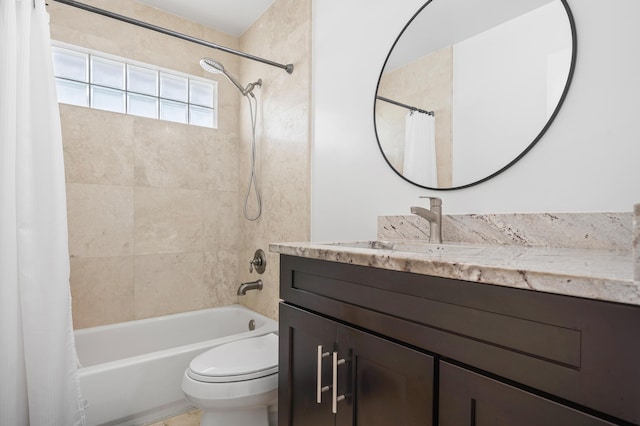 full bathroom featuring vanity, shower / tub combo, and toilet