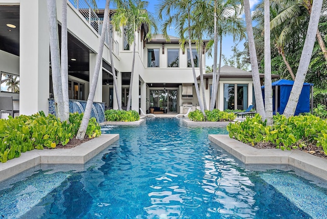 outdoor pool with grilling area and a patio area