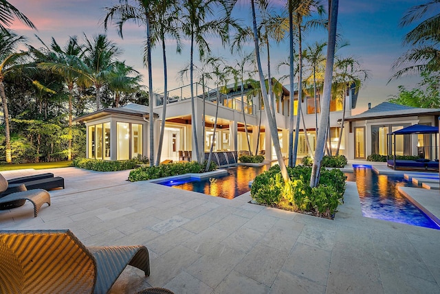 177 Commodore Dr, Jupiter, FL 33477 - property at dusk featuring an outdoor pool
