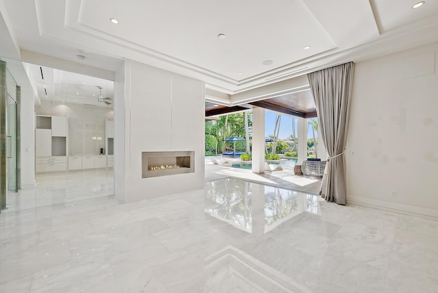 177 Commodore Dr, Jupiter, FL 33477 - unfurnished living room featuring marble tiled floors, recessed lighting, a fireplace, and a raised ceiling