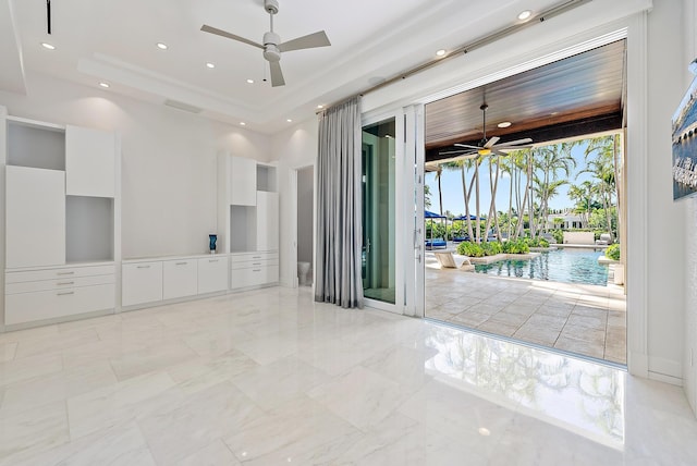 177 Commodore Dr, Jupiter, FL 33477 - unfurnished room with a ceiling fan, light marble finish flooring, a tray ceiling, and recessed lighting