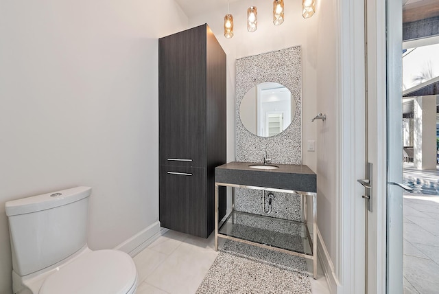 177 Commodore Dr, Jupiter, FL 33477 - bathroom featuring toilet, baseboards, and vanity