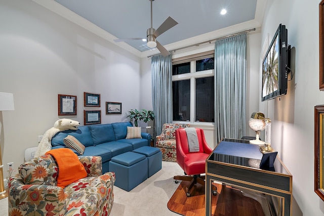 carpeted living area featuring a ceiling fan