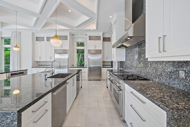 177 Commodore Dr, Jupiter, FL 33477 - kitchen with high end appliances, wall chimney exhaust hood, a sink, white cabinets, and coffered ceiling
