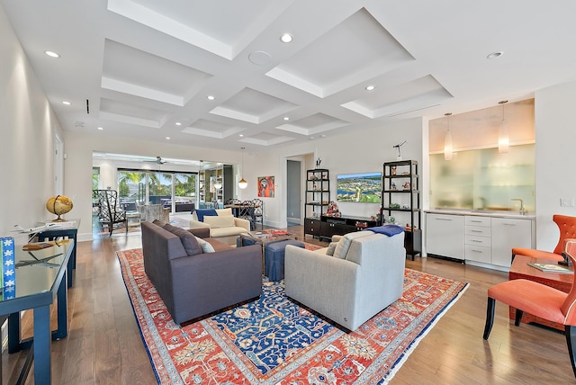 living room featuring baseboards, beam ceiling, recessed lighting, light wood-style flooring, and coffered ceiling