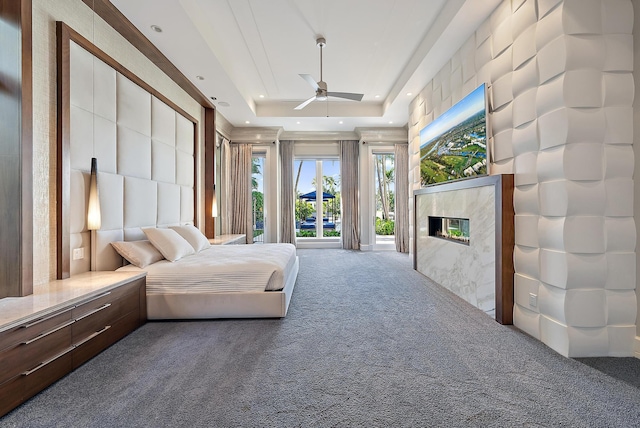 177 Commodore Dr, Jupiter, FL 33477 - bedroom featuring carpet flooring, a raised ceiling, recessed lighting, and a premium fireplace