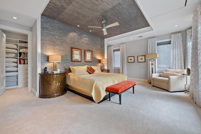 bedroom with visible vents, baseboards, a raised ceiling, and carpet