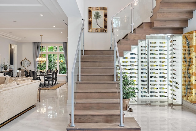 stairway featuring recessed lighting, marble finish floor, and ornamental molding