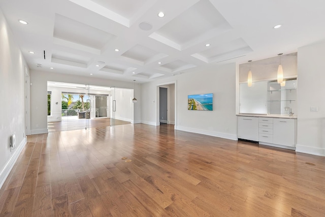 177 Commodore Dr, Jupiter, FL 33477 - unfurnished living room with coffered ceiling, light wood-style floors, baseboards, beamed ceiling, and recessed lighting