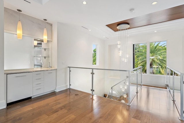 177 Commodore Dr, Jupiter, FL 33477 - hall featuring wood finished floors, plenty of natural light, recessed lighting, and a tray ceiling