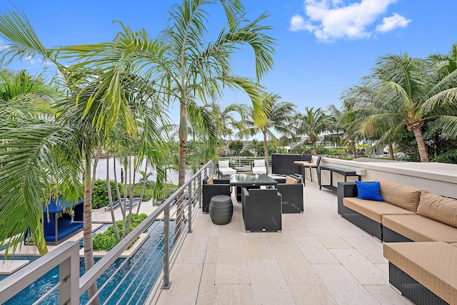 view of patio / terrace featuring an outdoor living space, an outdoor pool, and a balcony