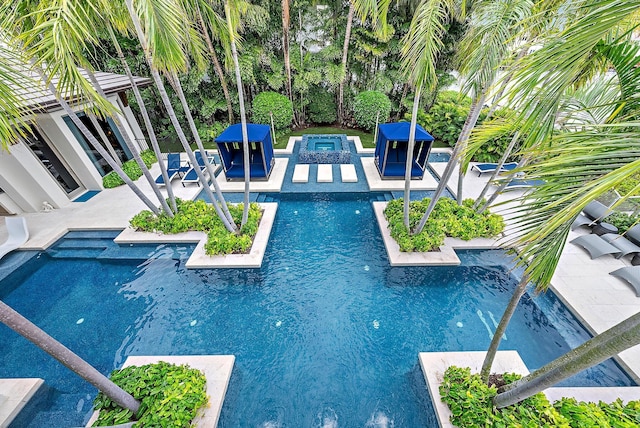 pool featuring an outdoor fire pit and a patio