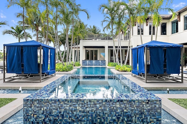 view of pool featuring an in ground hot tub