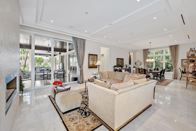 living area featuring recessed lighting, a raised ceiling, and marble finish floor