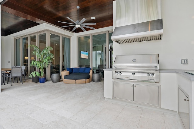 view of patio / terrace featuring exterior kitchen, area for grilling, and a ceiling fan