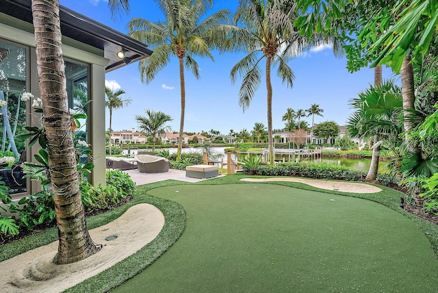 177 Commodore Dr, Jupiter, FL 33477 - view of home's community featuring a putting area, a water view, a residential view, and a patio