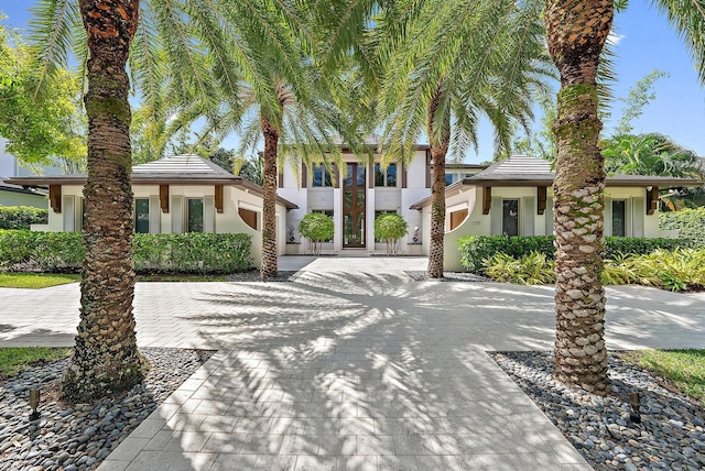 177 Commodore Dr, Jupiter, FL 33477 - view of front of home featuring stucco siding, decorative driveway, and an attached garage