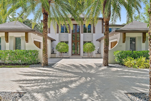 177 Commodore Dr, Jupiter, FL 33477 - view of front facade featuring stucco siding and french doors