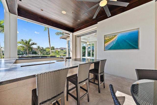 177 Commodore Dr, Jupiter, FL 33477 - dining space with wooden ceiling, stone tile floors, a ceiling fan, and recessed lighting