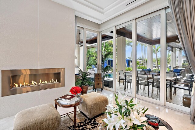 living area with a glass covered fireplace and a textured wall