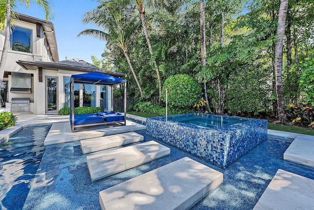 177 Commodore Dr, Jupiter, FL 33477 - view of pool with an in-ground hot tub, exterior kitchen, area for grilling, a gazebo, and a patio