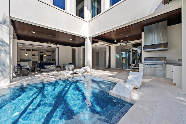 177 Commodore Dr, Jupiter, FL 33477 - view of pool with grilling area, a ceiling fan, an outdoor kitchen, a patio area, and a swimming pool