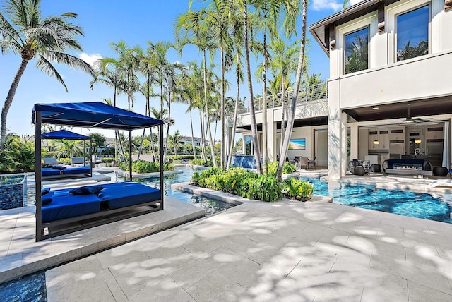 177 Commodore Dr, Jupiter, FL 33477 - view of patio featuring a balcony, an outdoor pool, and outdoor lounge area