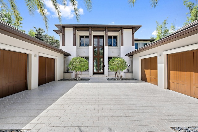177 Commodore Dr, Jupiter, FL 33477 - entrance to property with stucco siding and decorative driveway