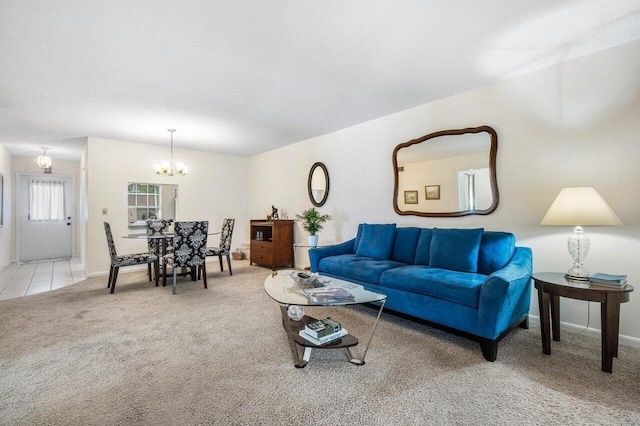 living room featuring light colored carpet, a textured ceiling, and a notable chandelier