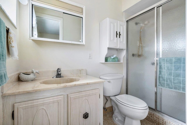 bathroom featuring tile patterned flooring, vanity, toilet, and walk in shower