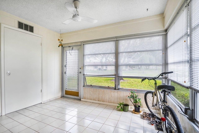 sunroom / solarium with a wealth of natural light and ceiling fan