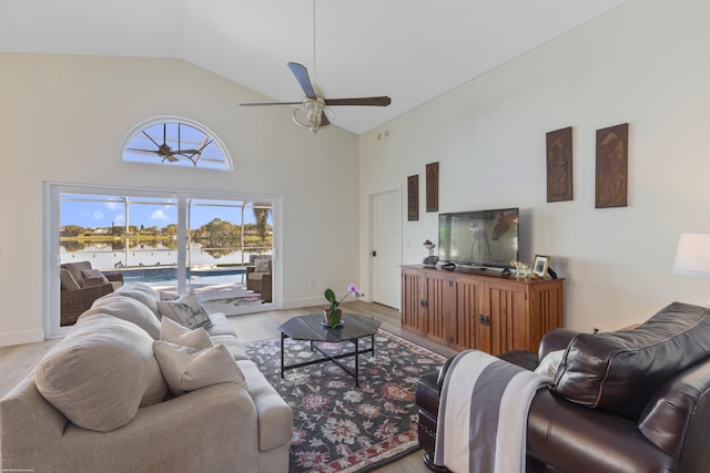 living room with ceiling fan, high vaulted ceiling, and light hardwood / wood-style floors