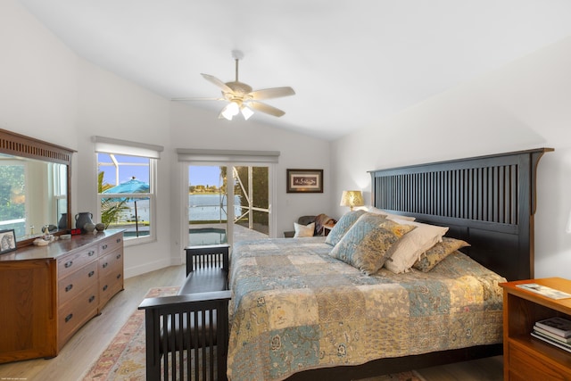 bedroom featuring multiple windows, access to exterior, vaulted ceiling, and light wood-type flooring