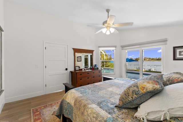 bedroom featuring access to exterior, hardwood / wood-style flooring, and ceiling fan