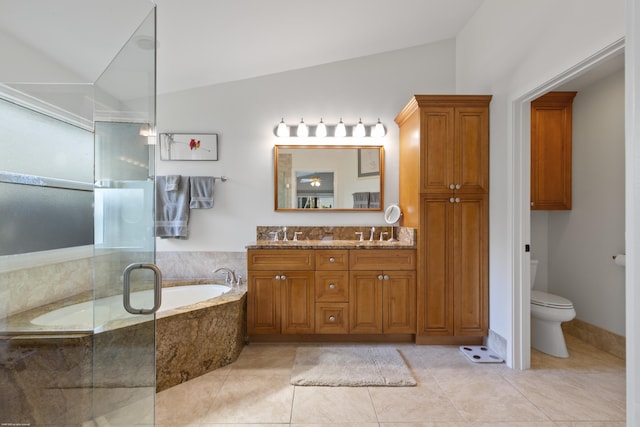 bathroom with tile patterned floors, toilet, vaulted ceiling, vanity, and a relaxing tiled tub