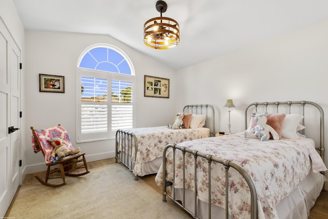 bedroom featuring vaulted ceiling and a notable chandelier
