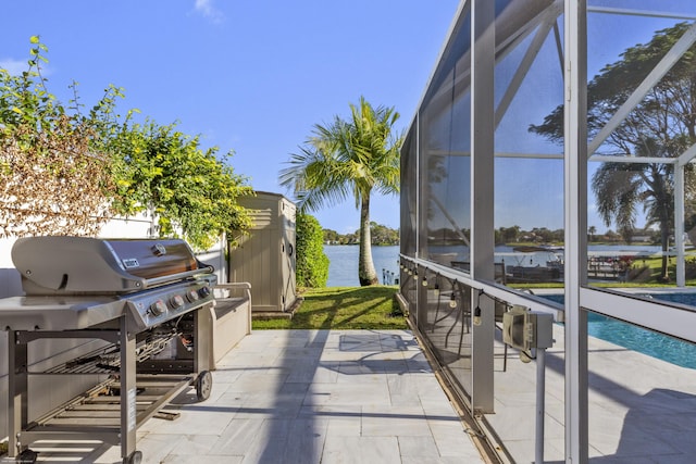 exterior space featuring a water view, a grill, and a lanai