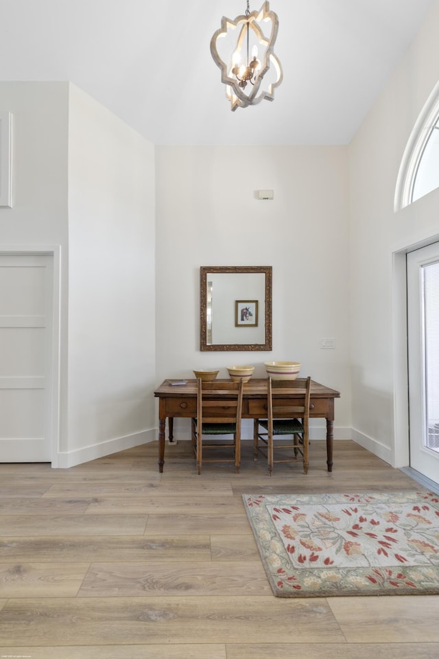 dining space featuring an inviting chandelier and light wood-type flooring