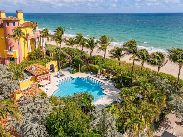 drone / aerial view with a water view and a beach view