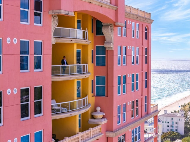 view of property with a water view and a view of the beach