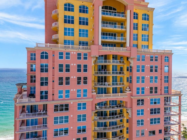 view of property with a beach view and a water view