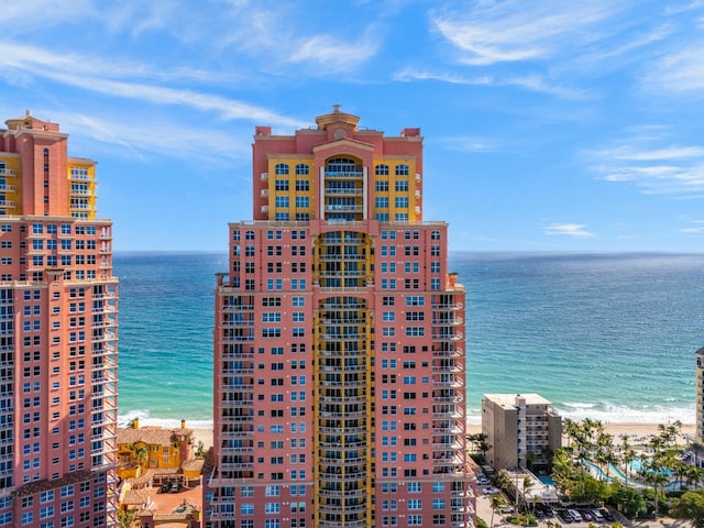 view of building exterior featuring a view of the beach and a water view